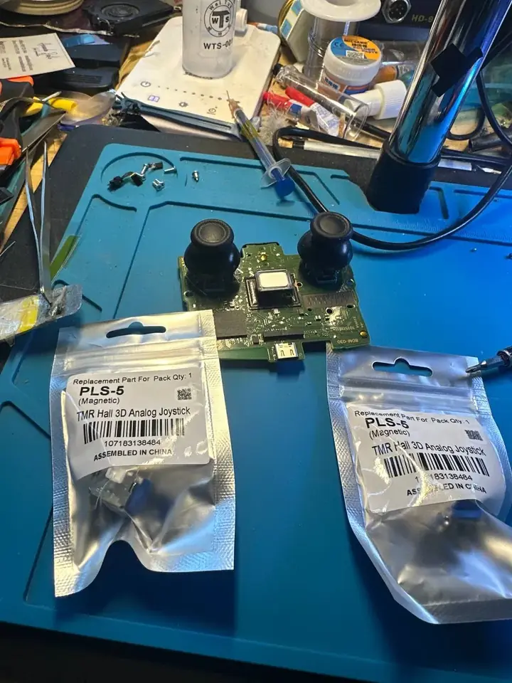 DualSense controller board fitted with joysticks beside TMR Hall-effect replacement parts