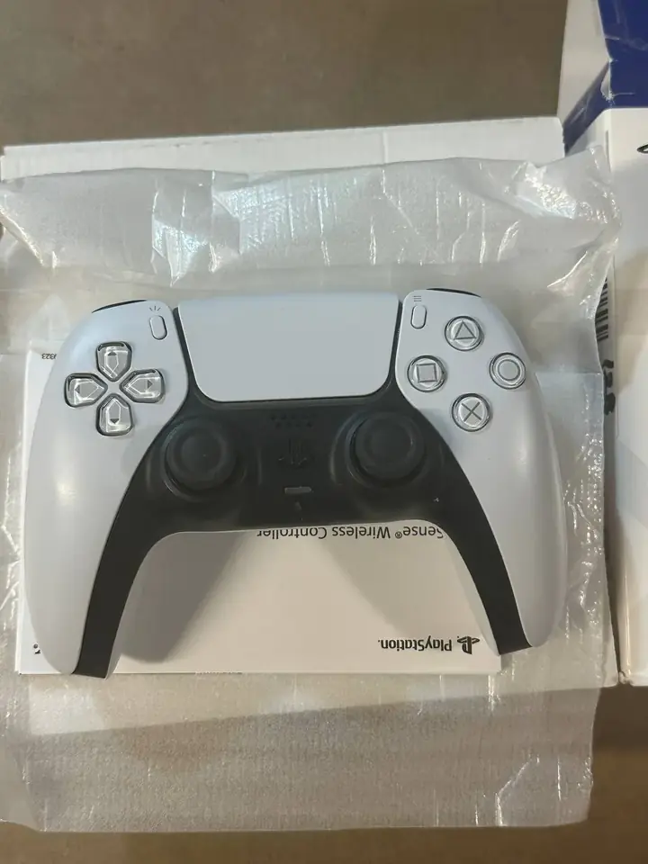 White PS5 DualSense controller sitting in its original box