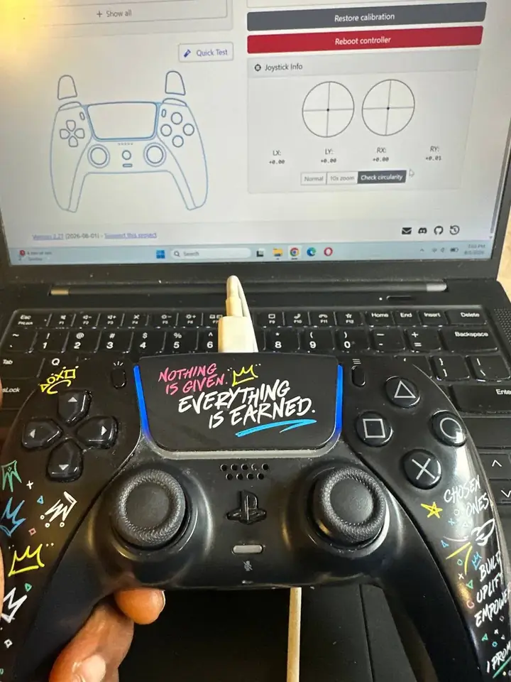Repaired PS5 DualSense controller connected to calibration software showing both sticks centred with zero drift