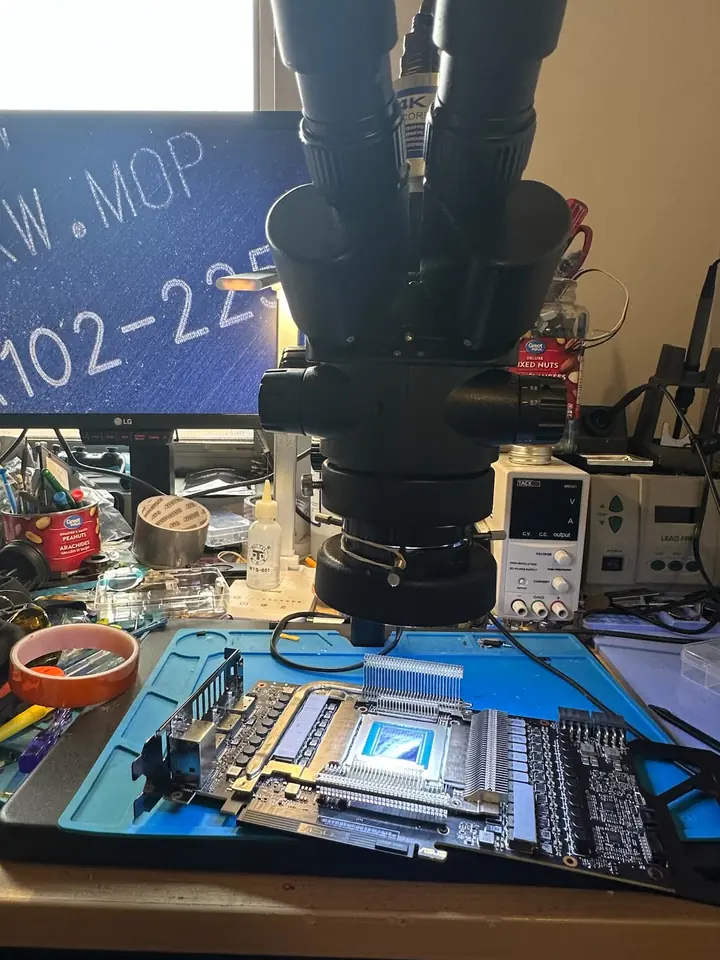 Graphics card PCB inspected under a bench microscope