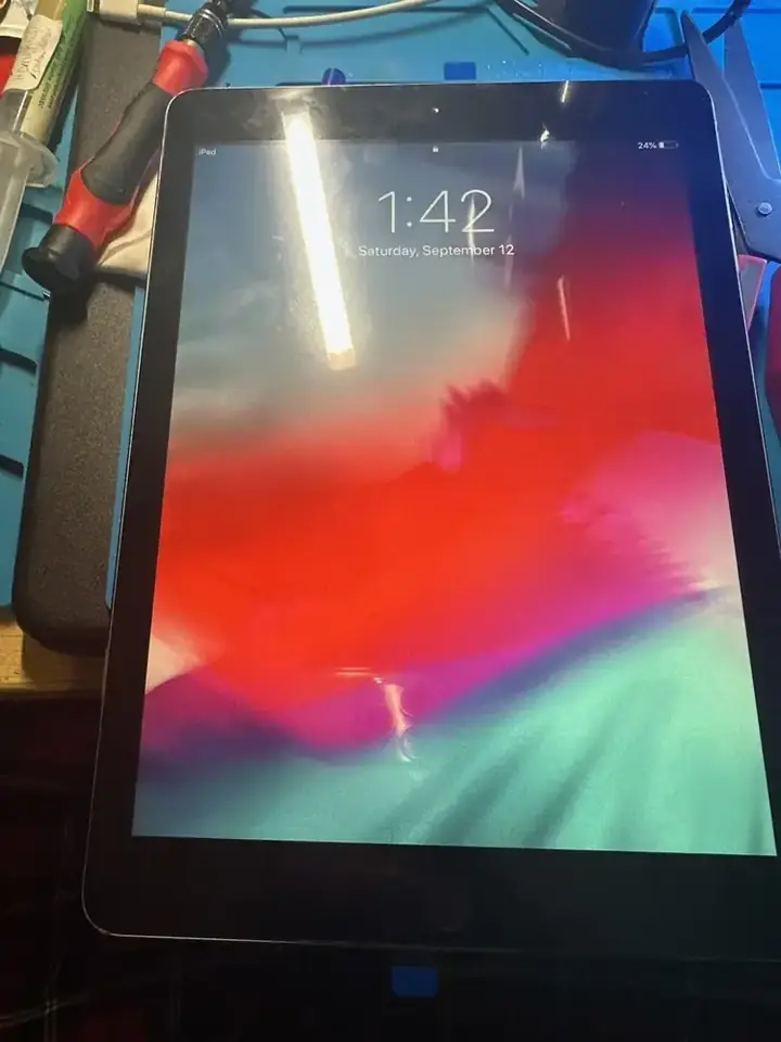iPad display powered on for a final screen test after repair