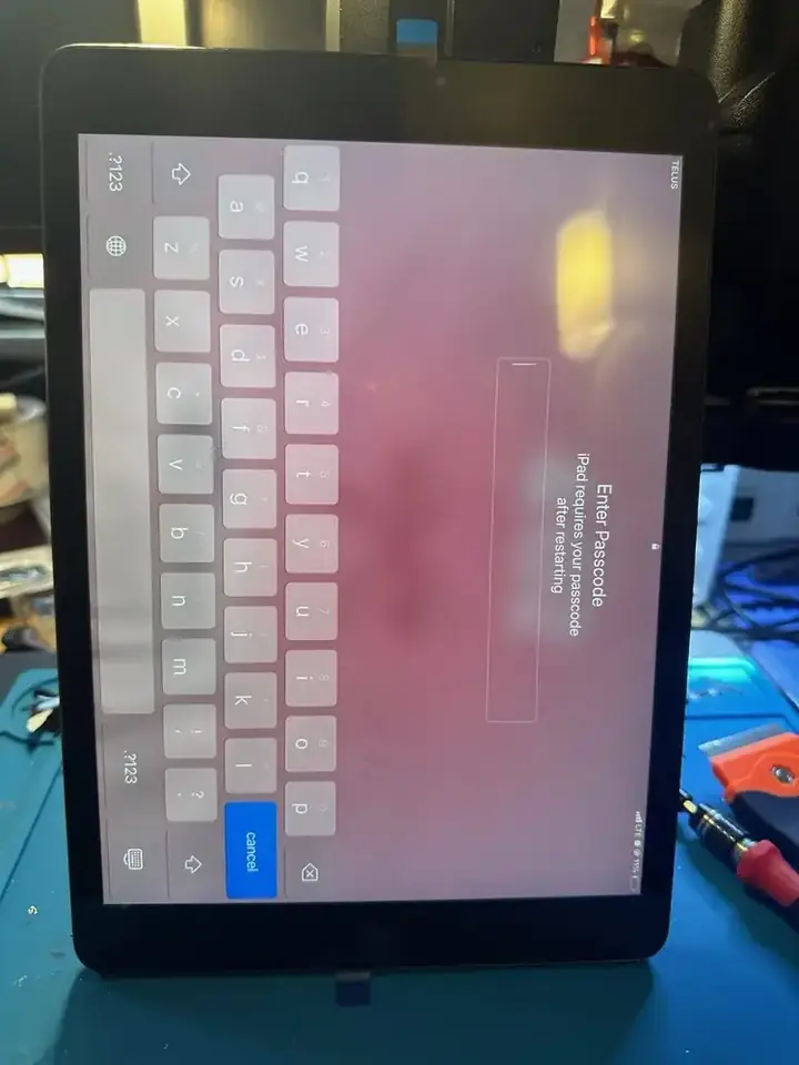 iPad on-screen keyboard used to test touchscreen response after repair