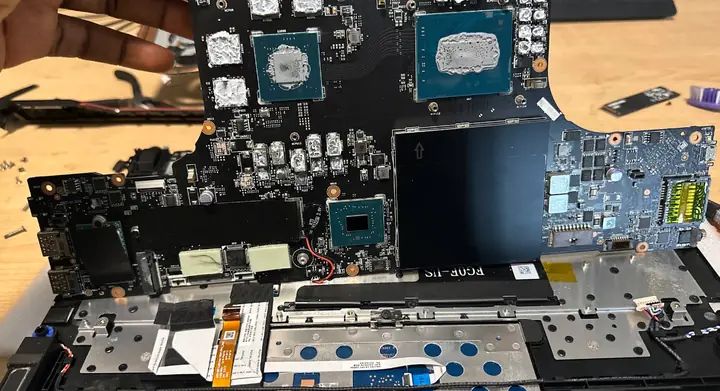 Laptop motherboard inspected during a FlexRepairs computer repair