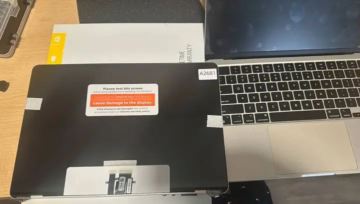 Replacement laptop display panel prepared beside the computer