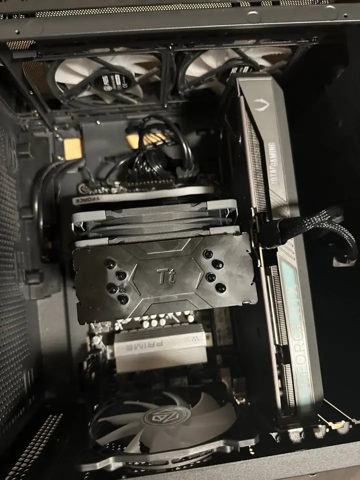 Close-up view of CPU cooler heatsink fins, dual fans and graphics card