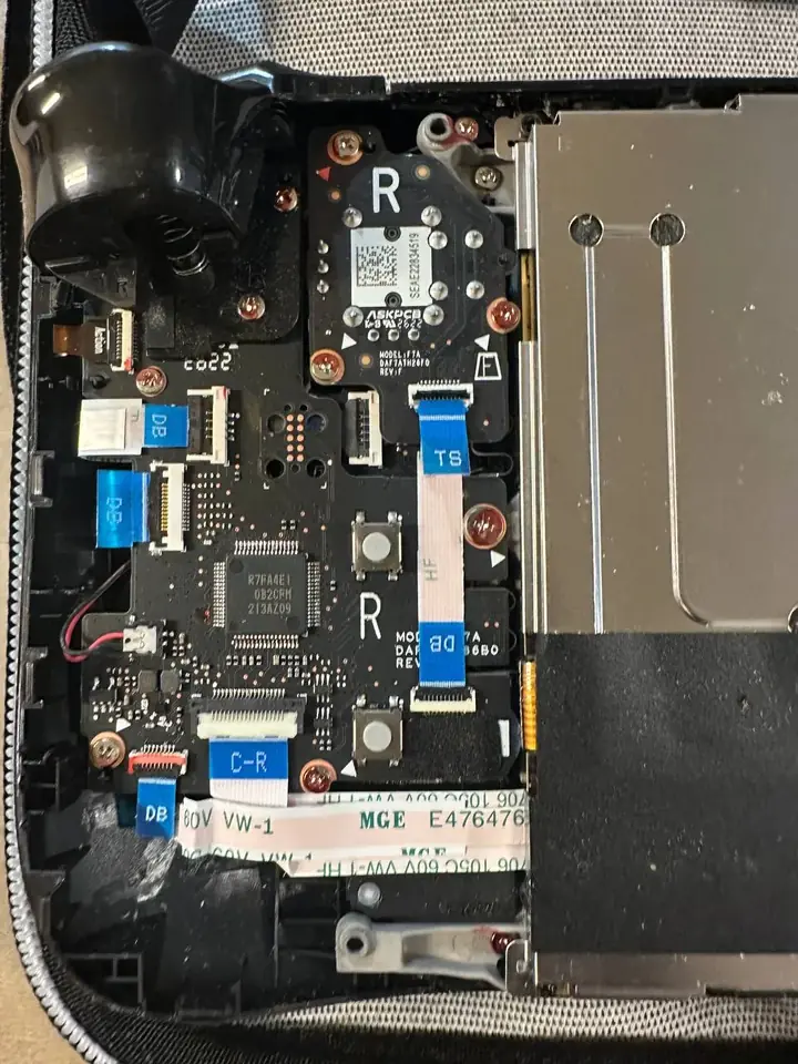 Valve Steam Deck opened with the original right thumbstick board exposed before replacement