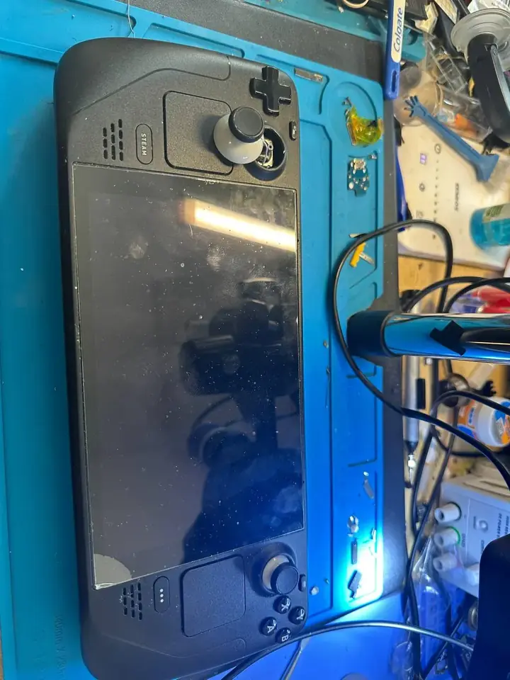 Valve Steam Deck on the repair bench during thumbstick replacement