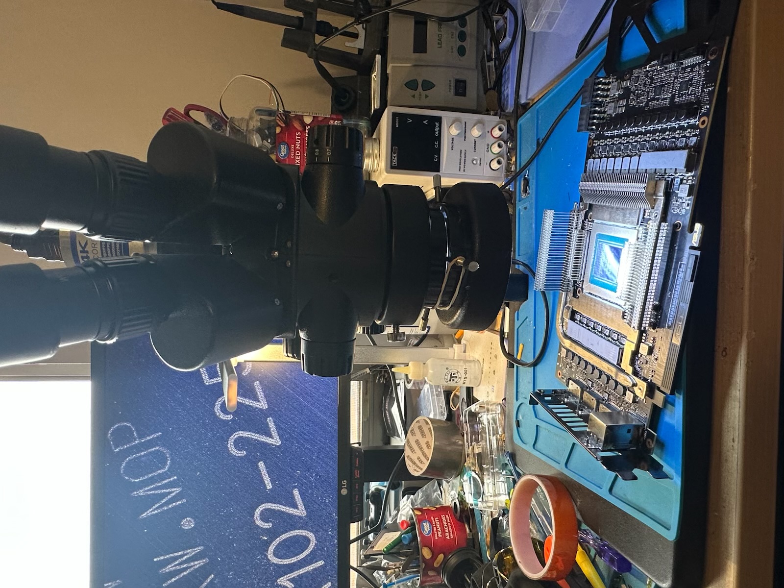 Graphics card PCB inspected under a bench microscope