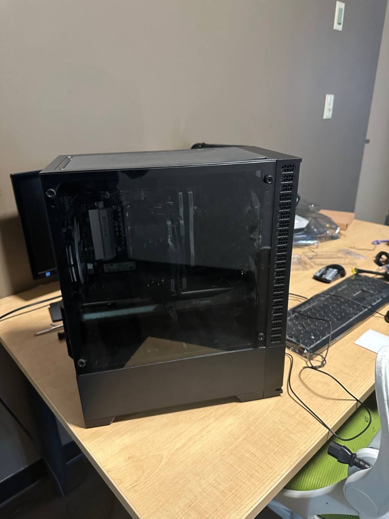 Completed custom gaming PC in modern glass case with RGB illumination