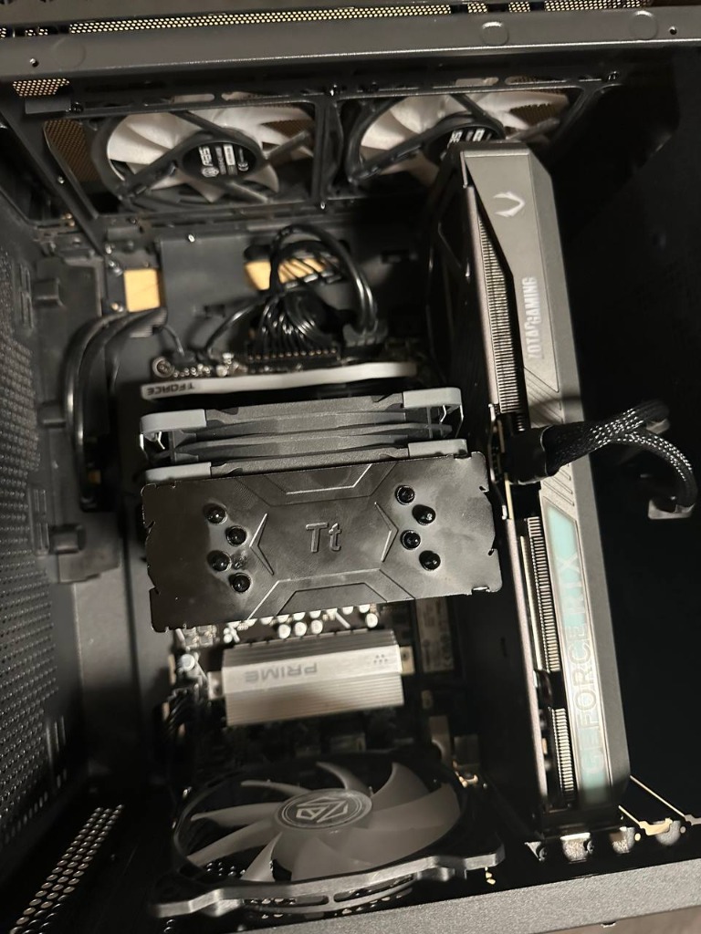 Close-up view of CPU cooler heatsink fins, dual fans and graphics card