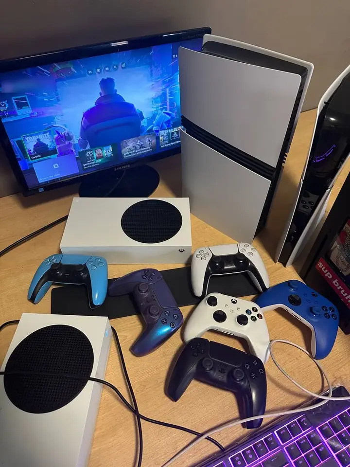 Xbox Series S consoles, a PS5 and controllers lined up on the FlexRepairs test bench